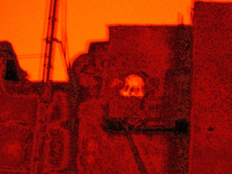 Exculpated Sky, a visual poem by Robert Frede Kenter grainy urban tenements blurred and dreamlike in shades of brown, red, orange.