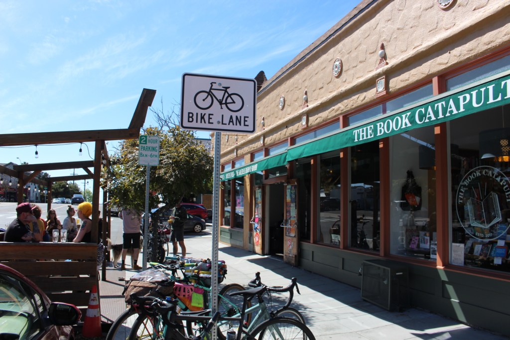 Photo of sidewalk and outdoor cafe area of The Book Catapult. Image by Chantal B. 