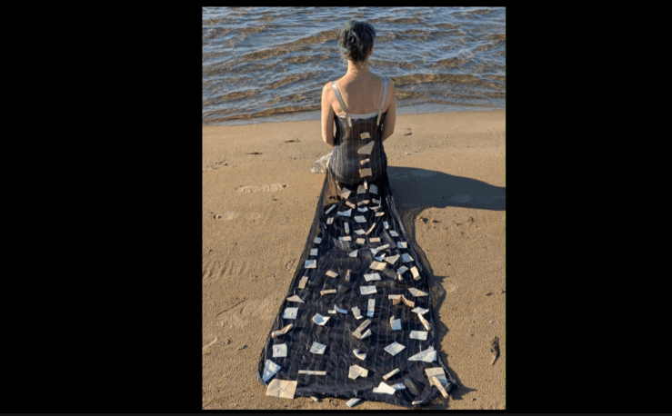 Screenshot from short video film by Shannon Quinn Shannon in dress looking out on Lake Ontario.