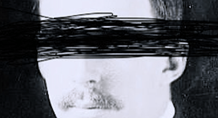 A black and white image of a blindfolded man -- the blindfold is scribbled black marker over the 40-something mustachioed face, seems from another era -- early 20th century